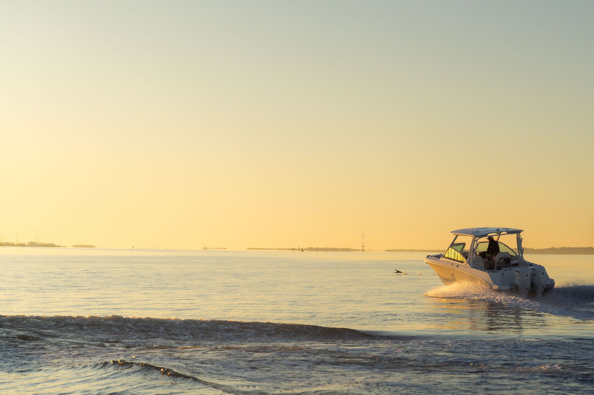 Stingray boat cruising on calm water during sunset, showcasing sleek design and performance.