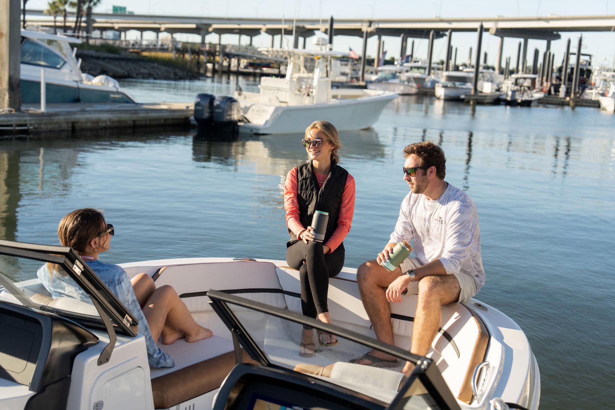 Stingray boat with people enjoying a day on the water at the marina. Perfect for boating, fishing.